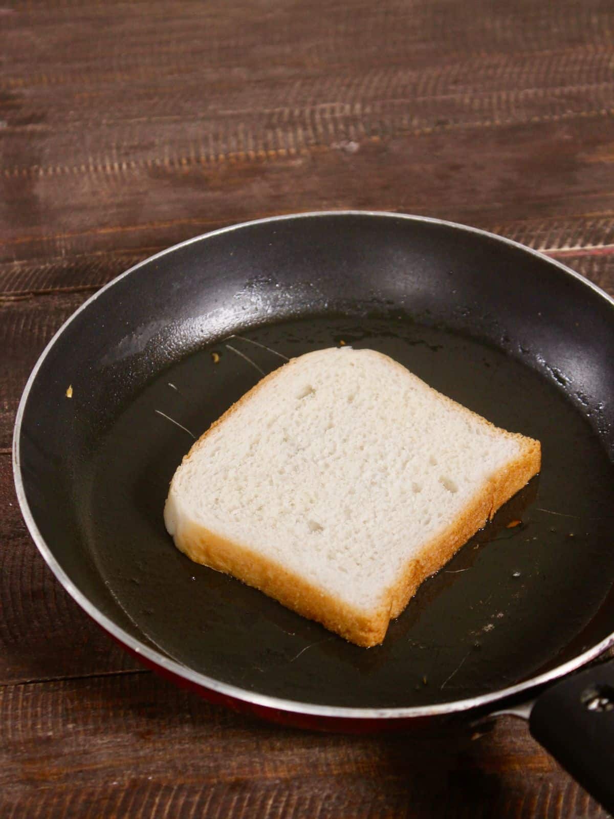 take bread slice and ghee in a pan 