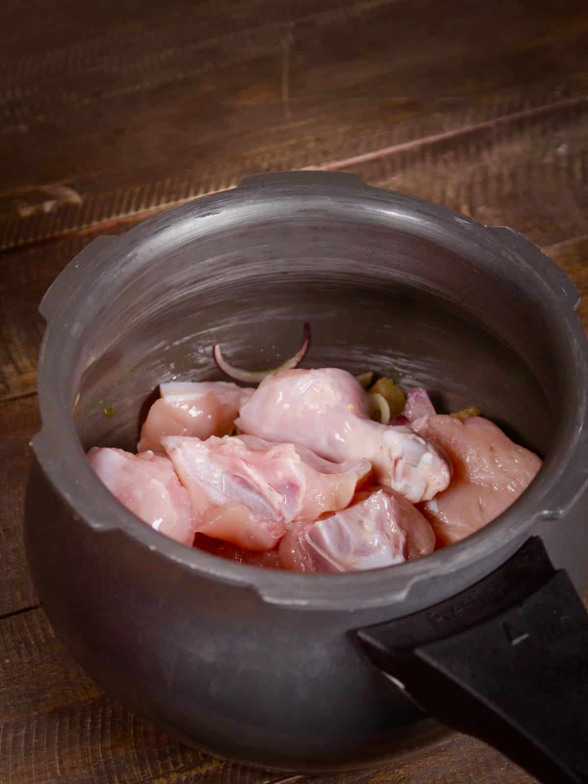 add chicken pieces to the pressure cooker 