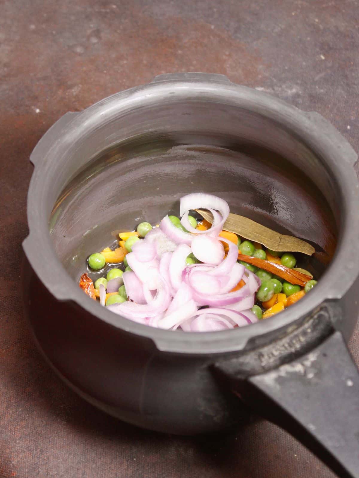 add chopped vegetables in the pressure cooker  