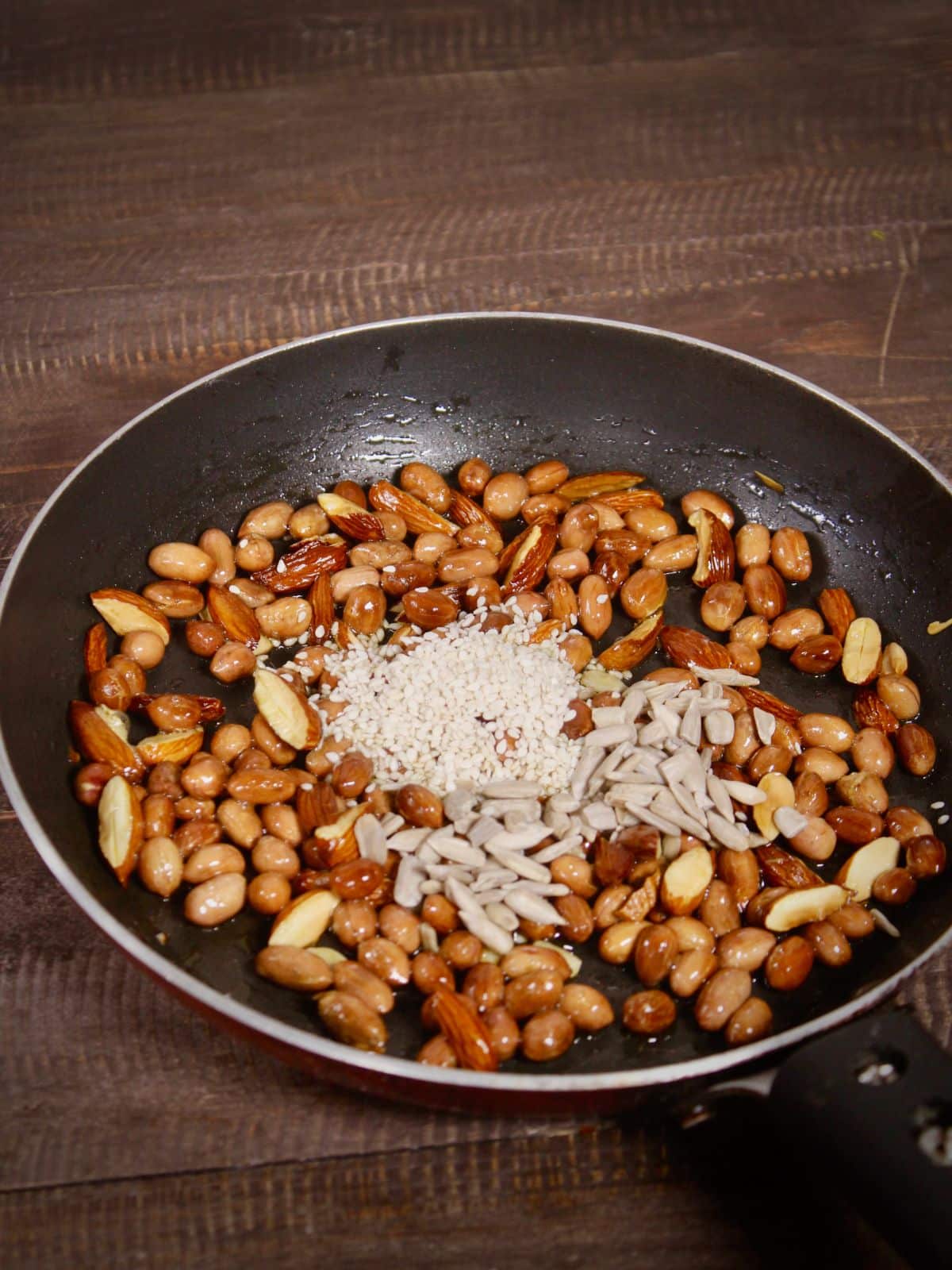 add sesame and watermelon seeds to the peanuts and mix well 