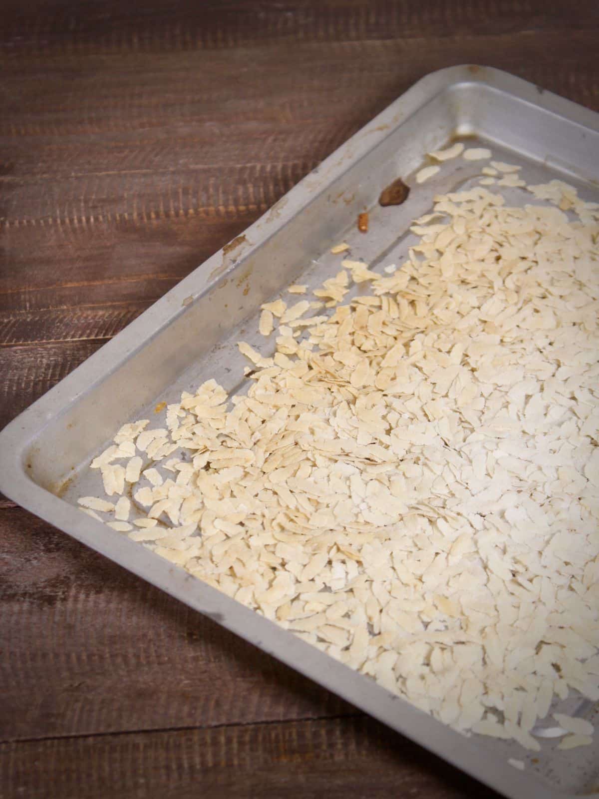 take flattened rice on a baking tray and bake 