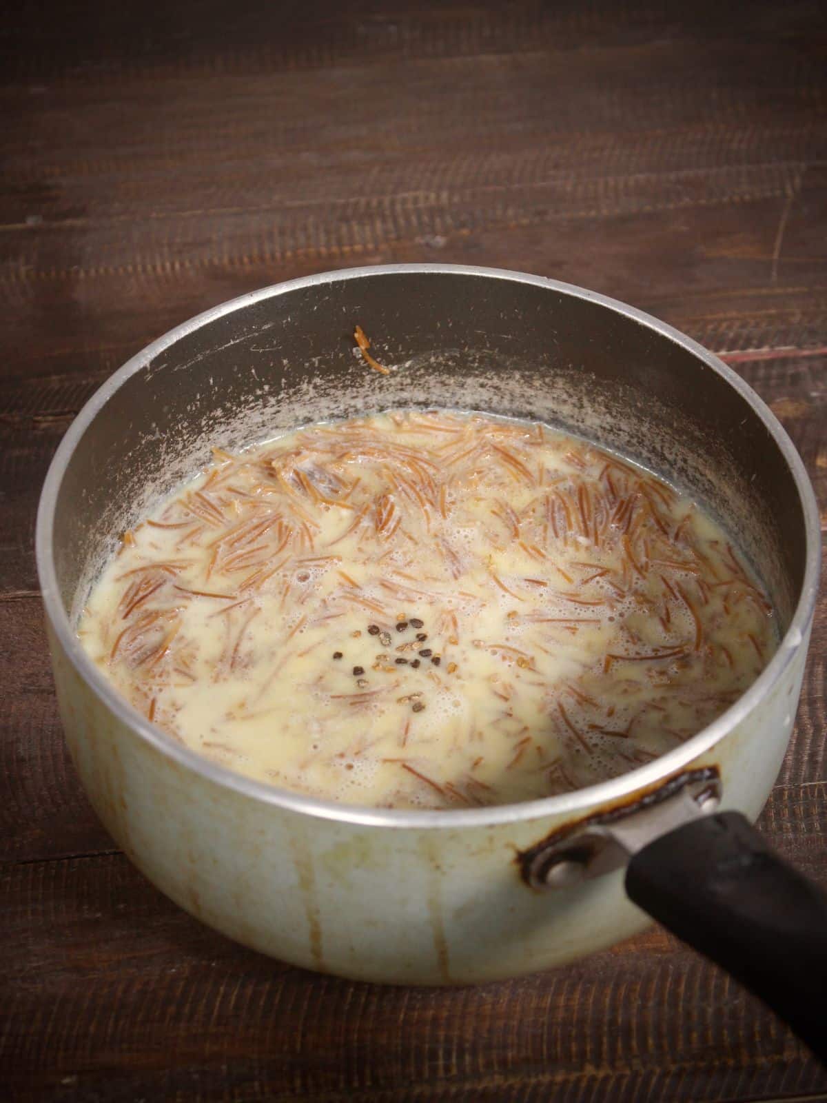 add sugar and cardamom pods to the pan 