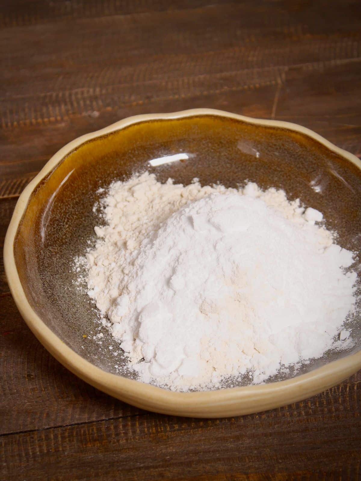 add flour, baking soda, baking powder and powdered sugar in a bowl   
