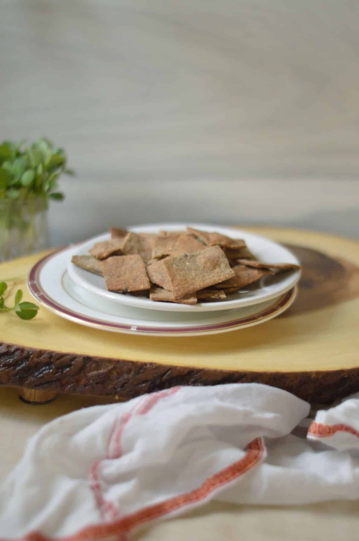 Air Fryer Crackers on a white plate on a wooden board.