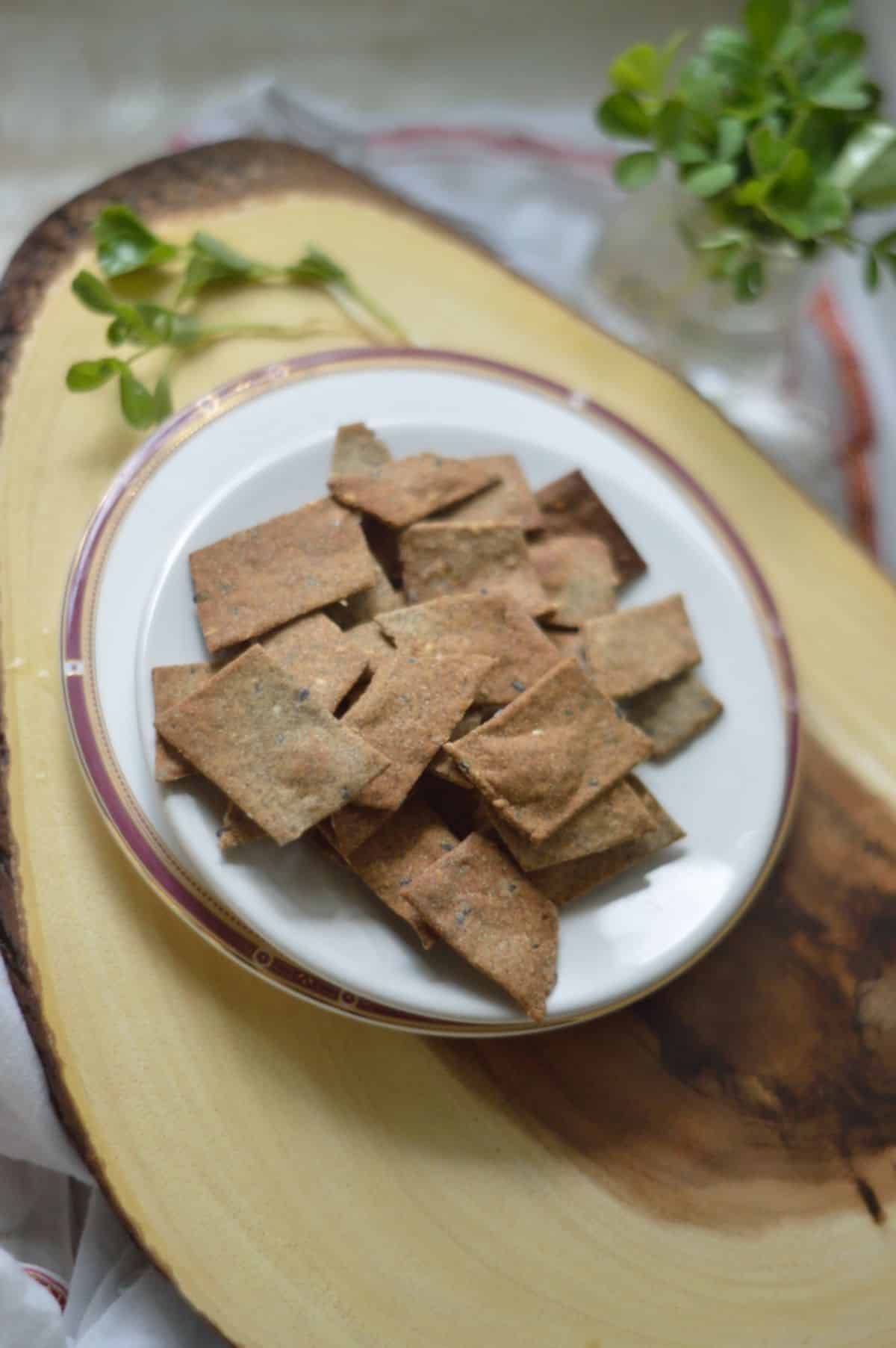 Air Fryer Crackers on a white plate on a wooden board.