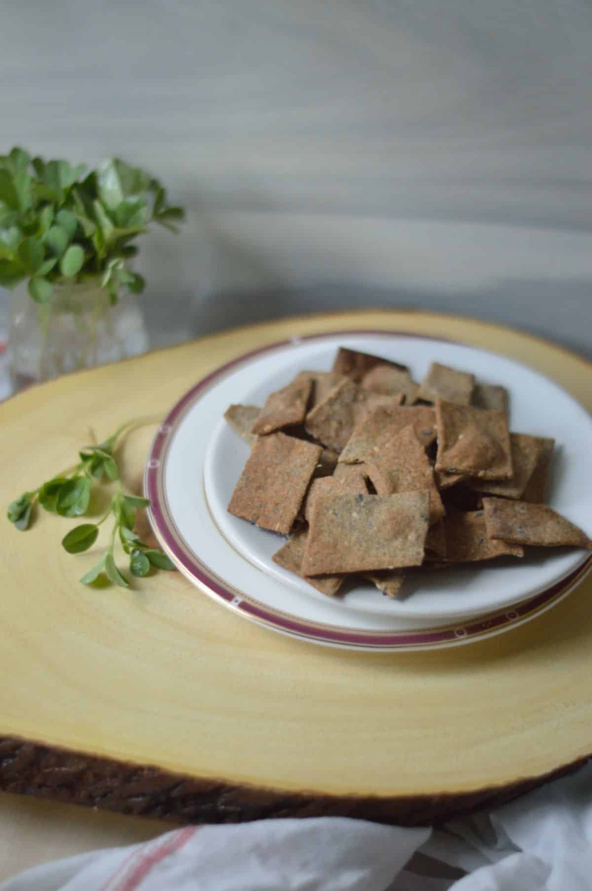 Air Fryer Crackers on a white plate on a wooden board.