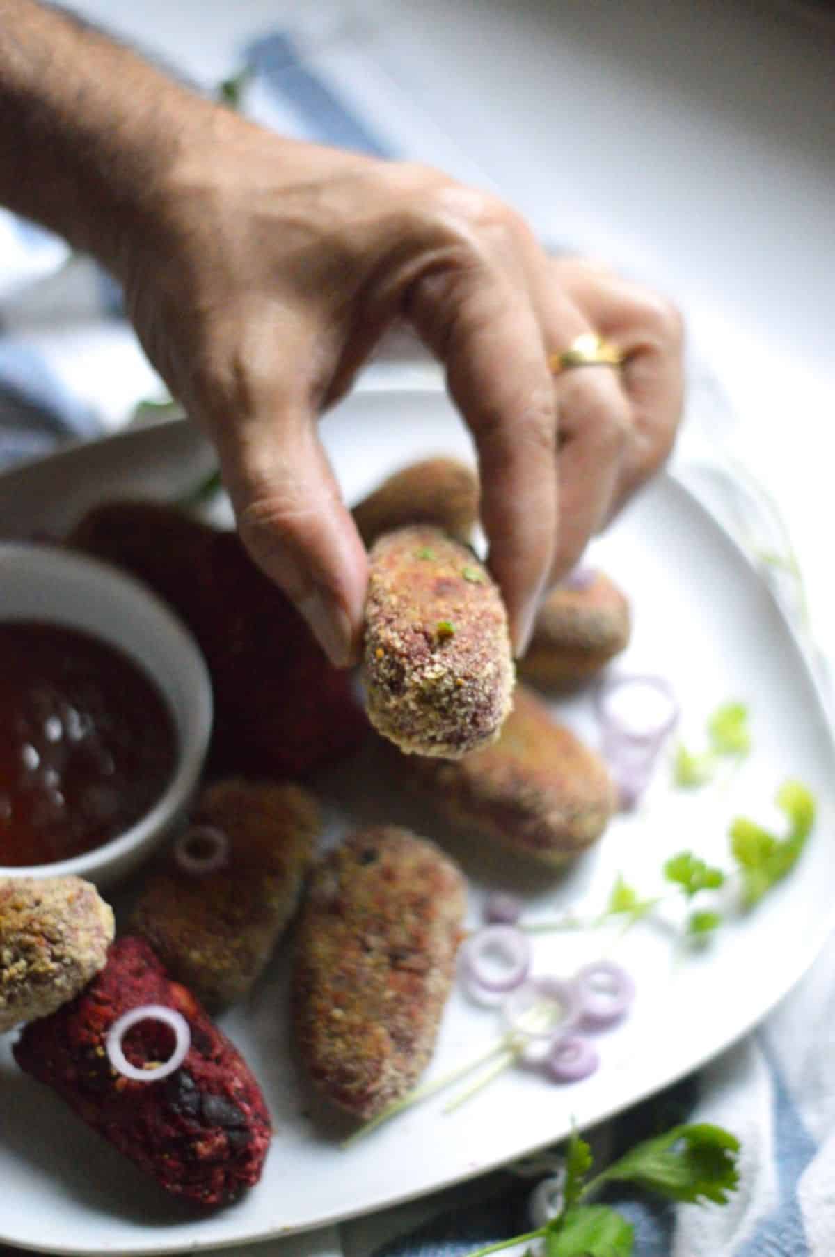 Air Fryer Veggie Cutlet held by hand,