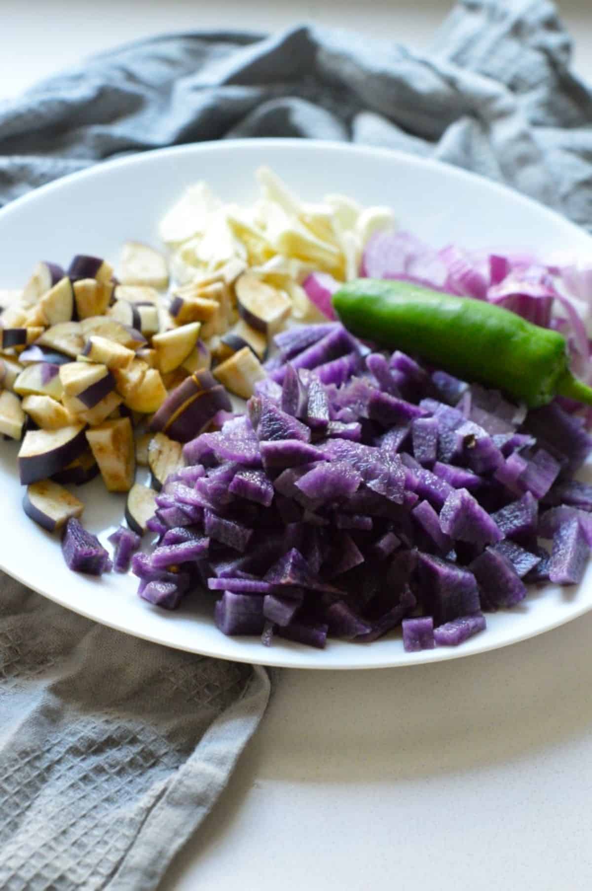 Chopped veggies on a white plate.