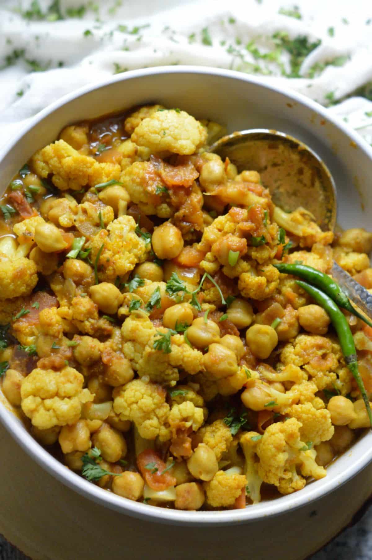 Chana Gobi Masala dish in a white bowl.