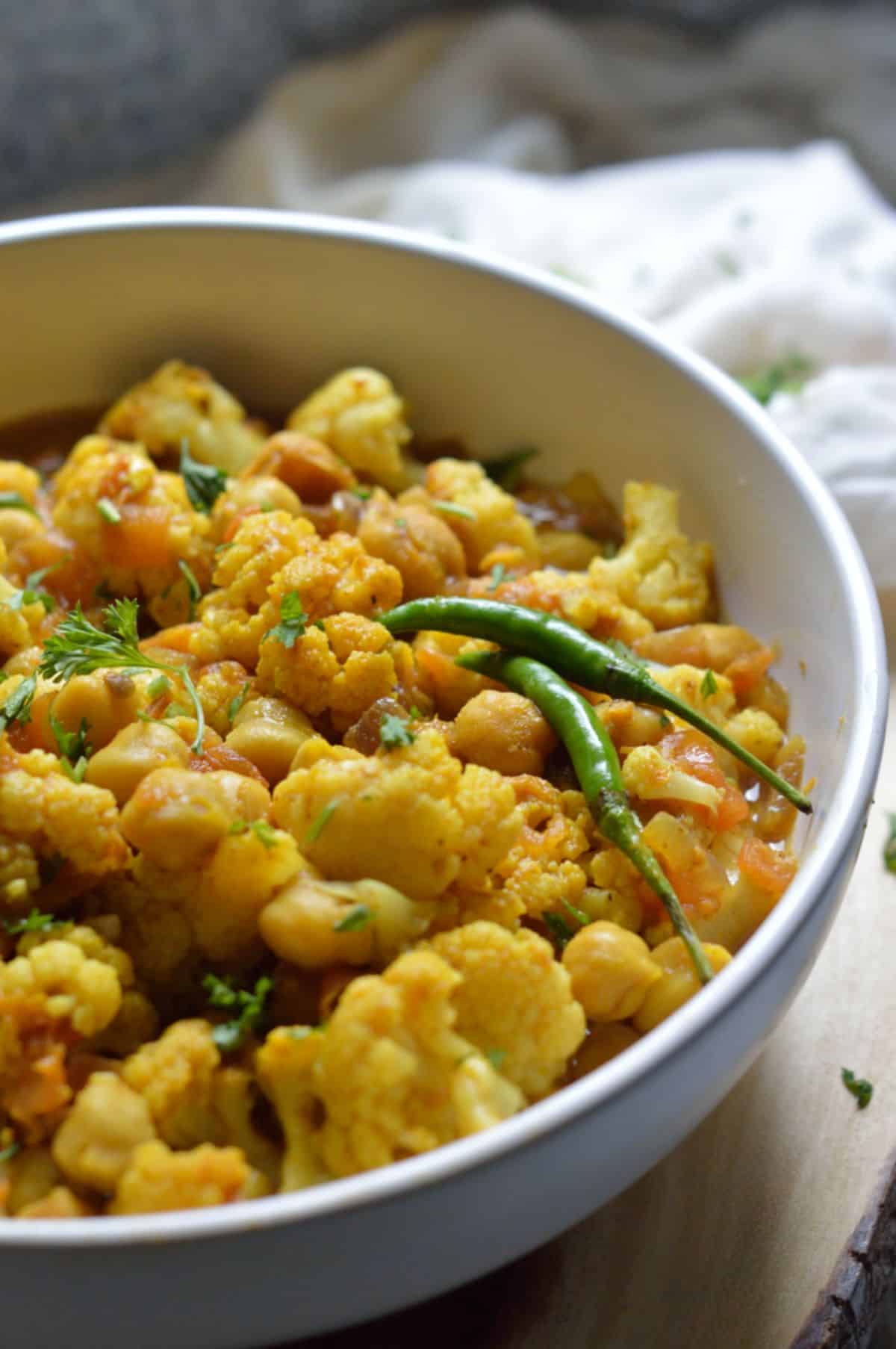 Chana Gobi Masala dish in a white bowl.