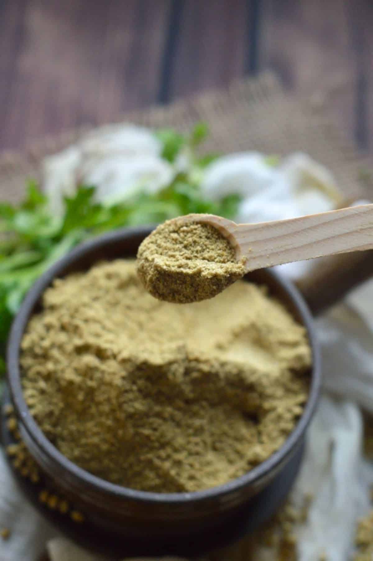 Coriander Powder on a wooden spoon.