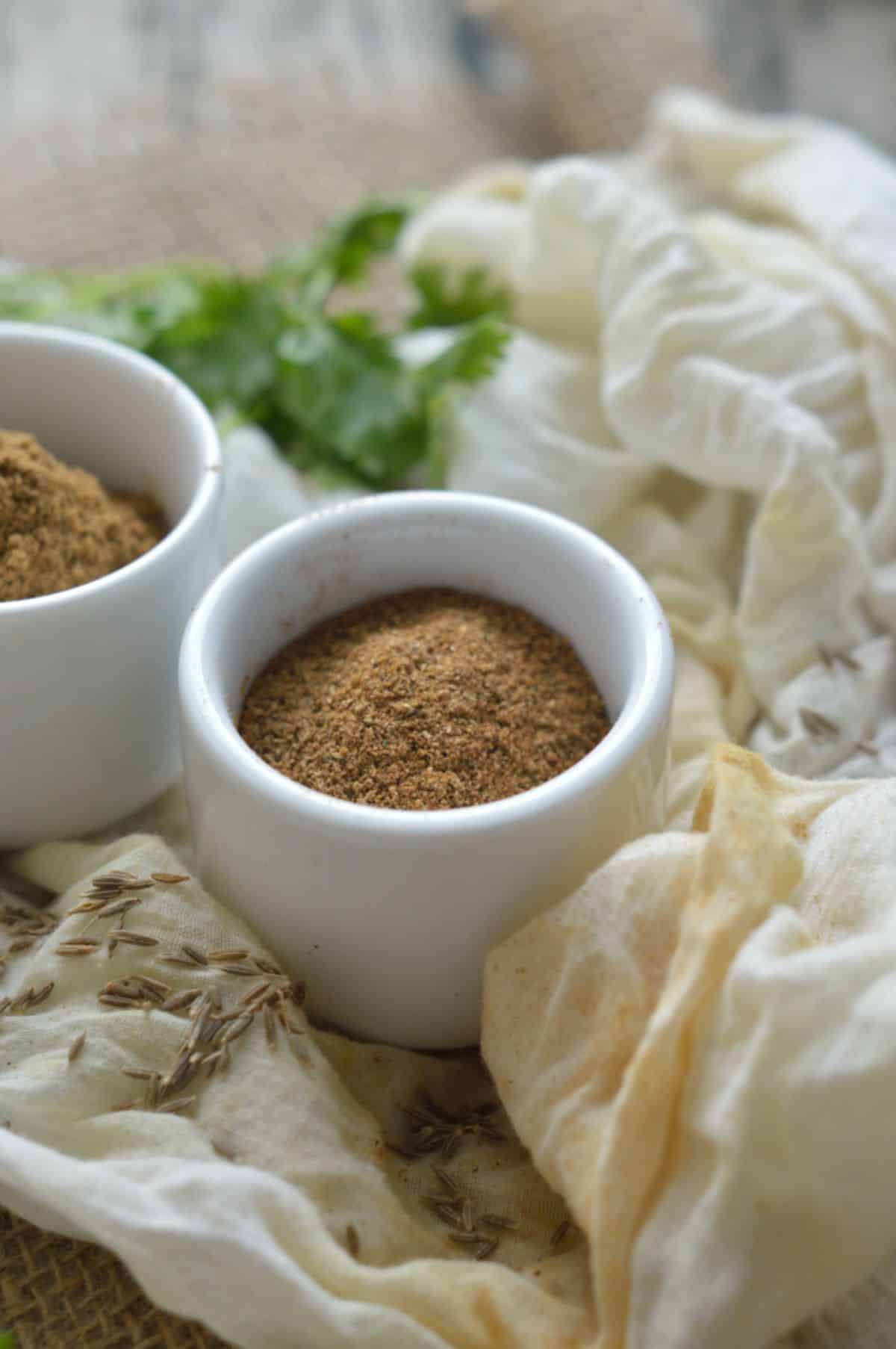 Cumin Powder in two white bowls.