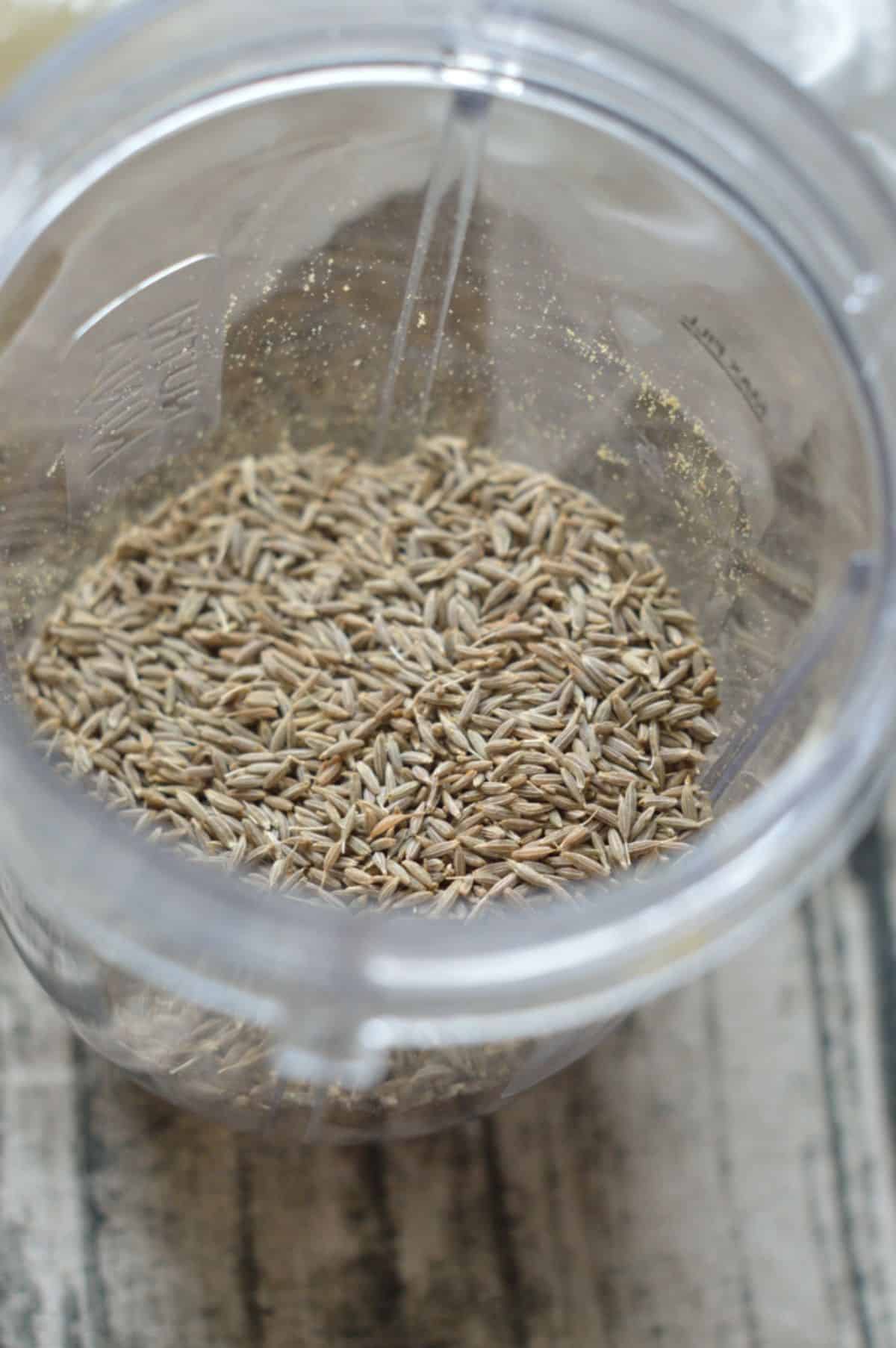 Roasted cumin seeds in a blender.