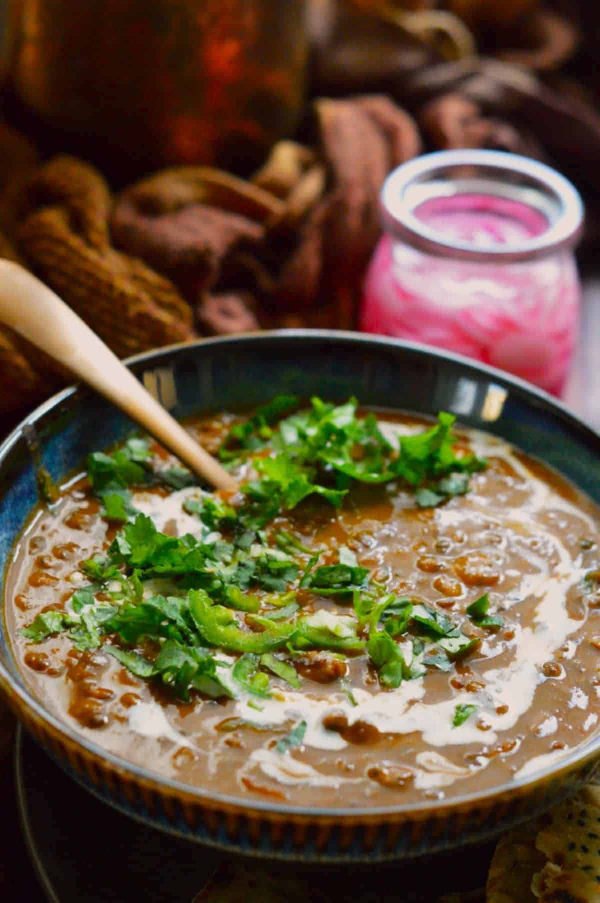 Dal Makhni dish in a blue bowl with a spoon.