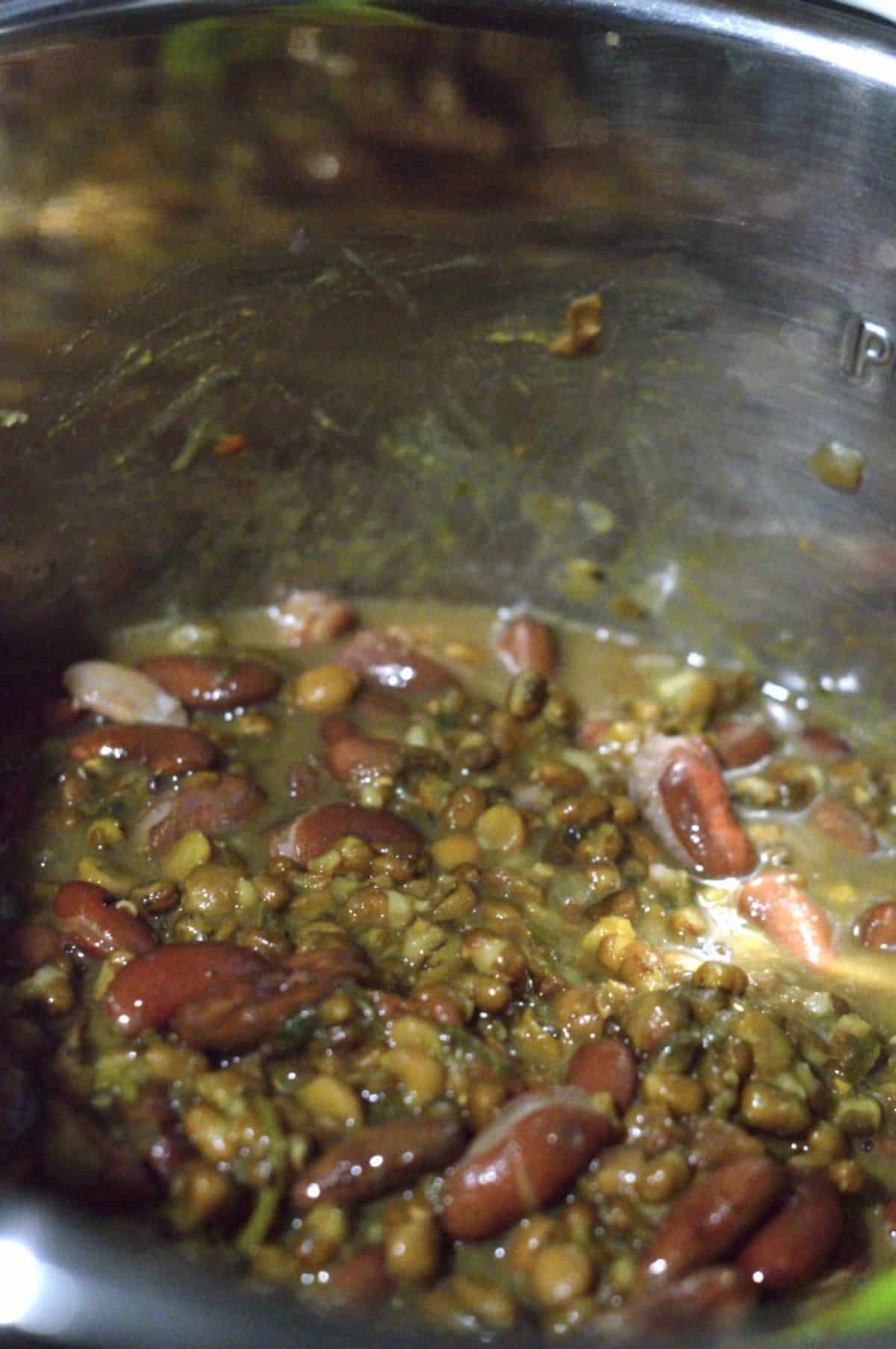 Dal Makhni ingredients cooking in a pot.