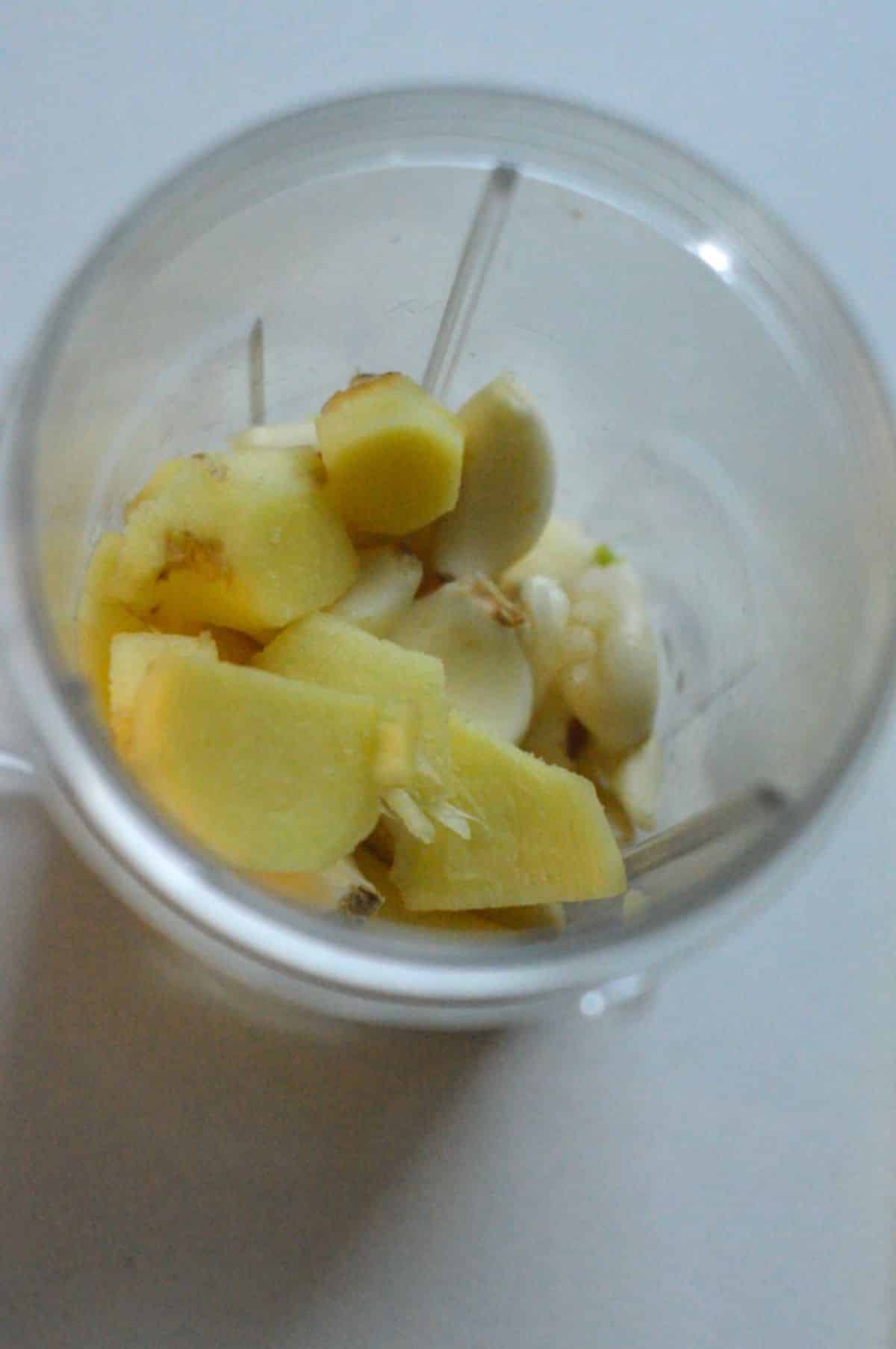 Sliced ginger root and peeled garlic cloved in a blender.
