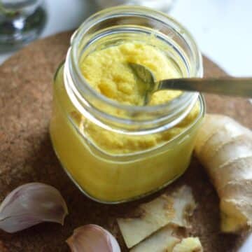 Ginger Garlic Paste in a glass jar with a spoon.