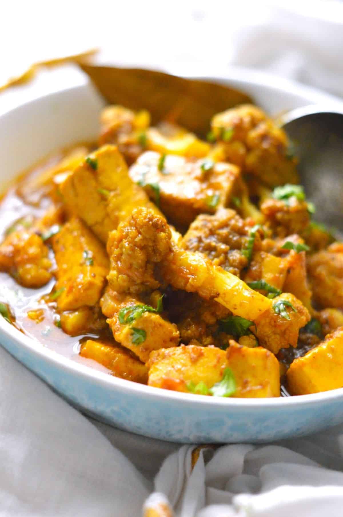 Gobi Paneer dish in a blue-white bowl.