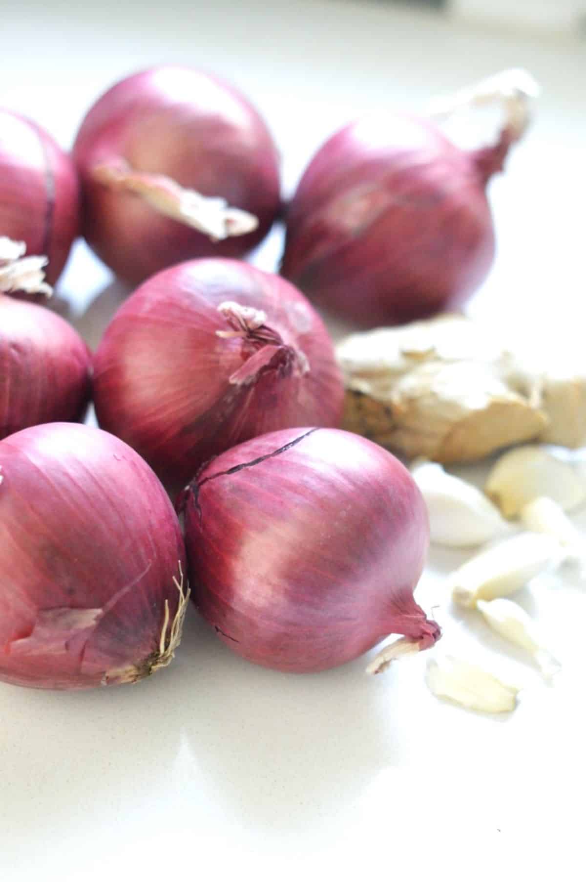 Whole red onions, garlic and ginger.