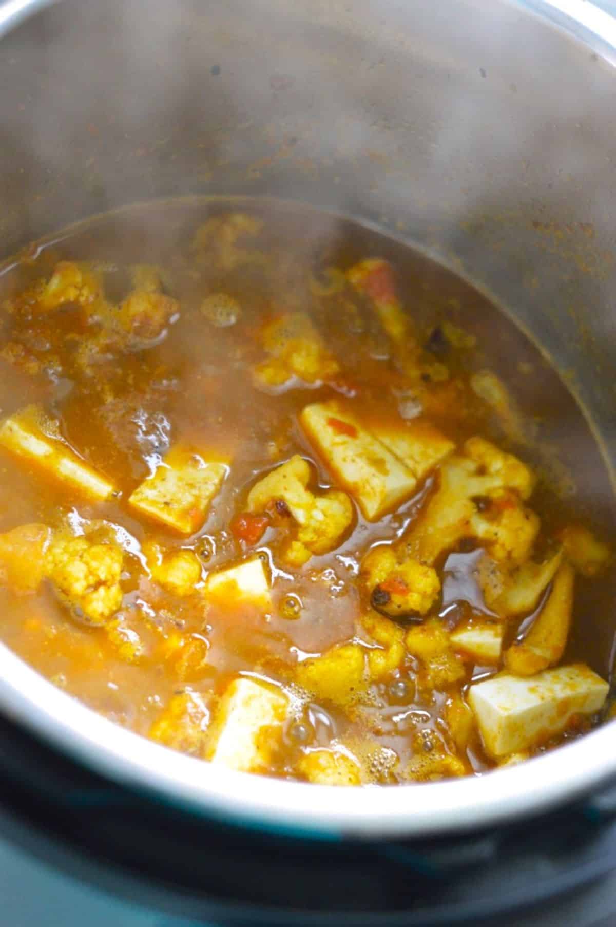 Gobi Paneer boiling dish in a pot.