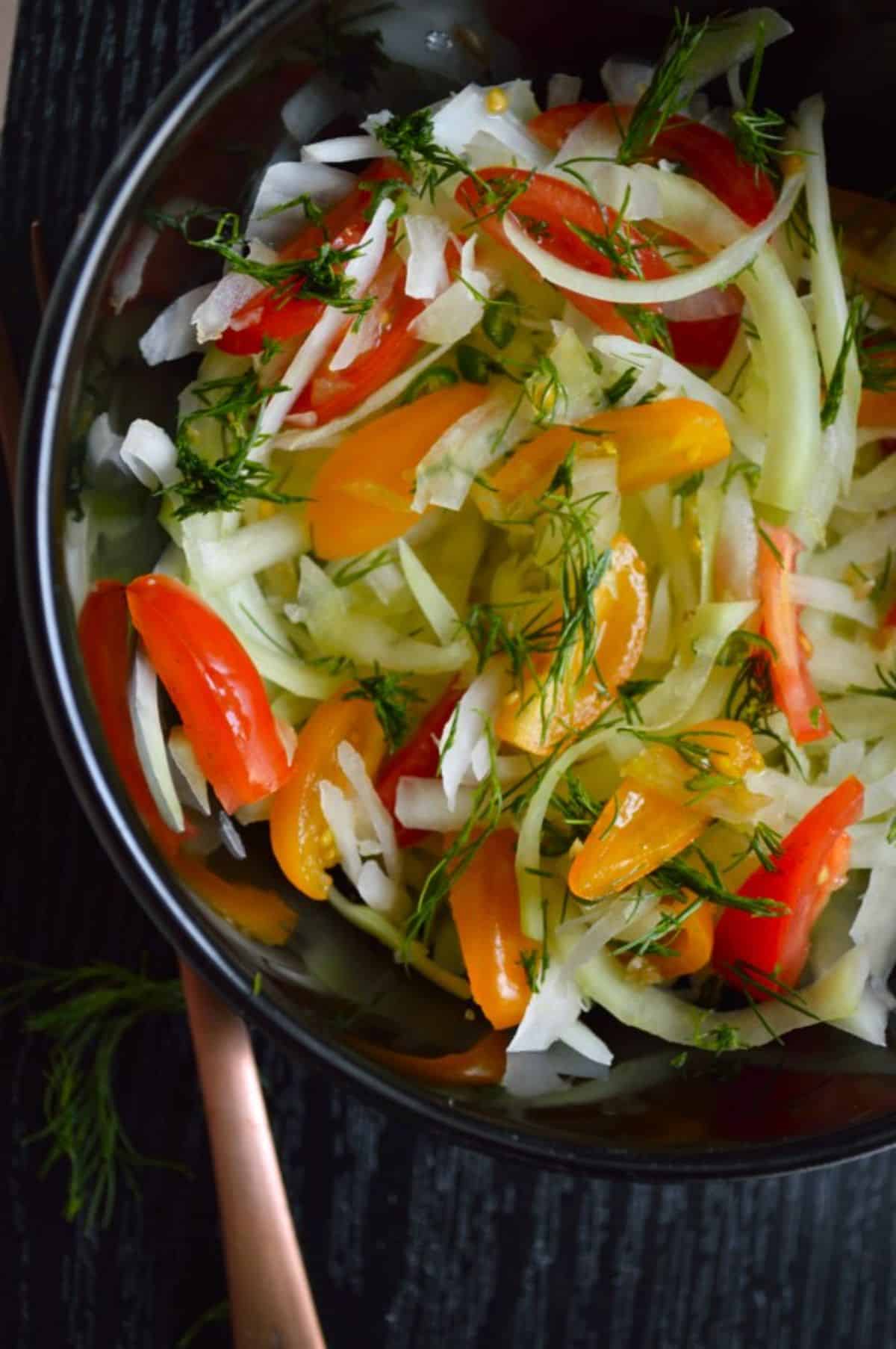 Vegan Green Papaya Salad in a black bowl.