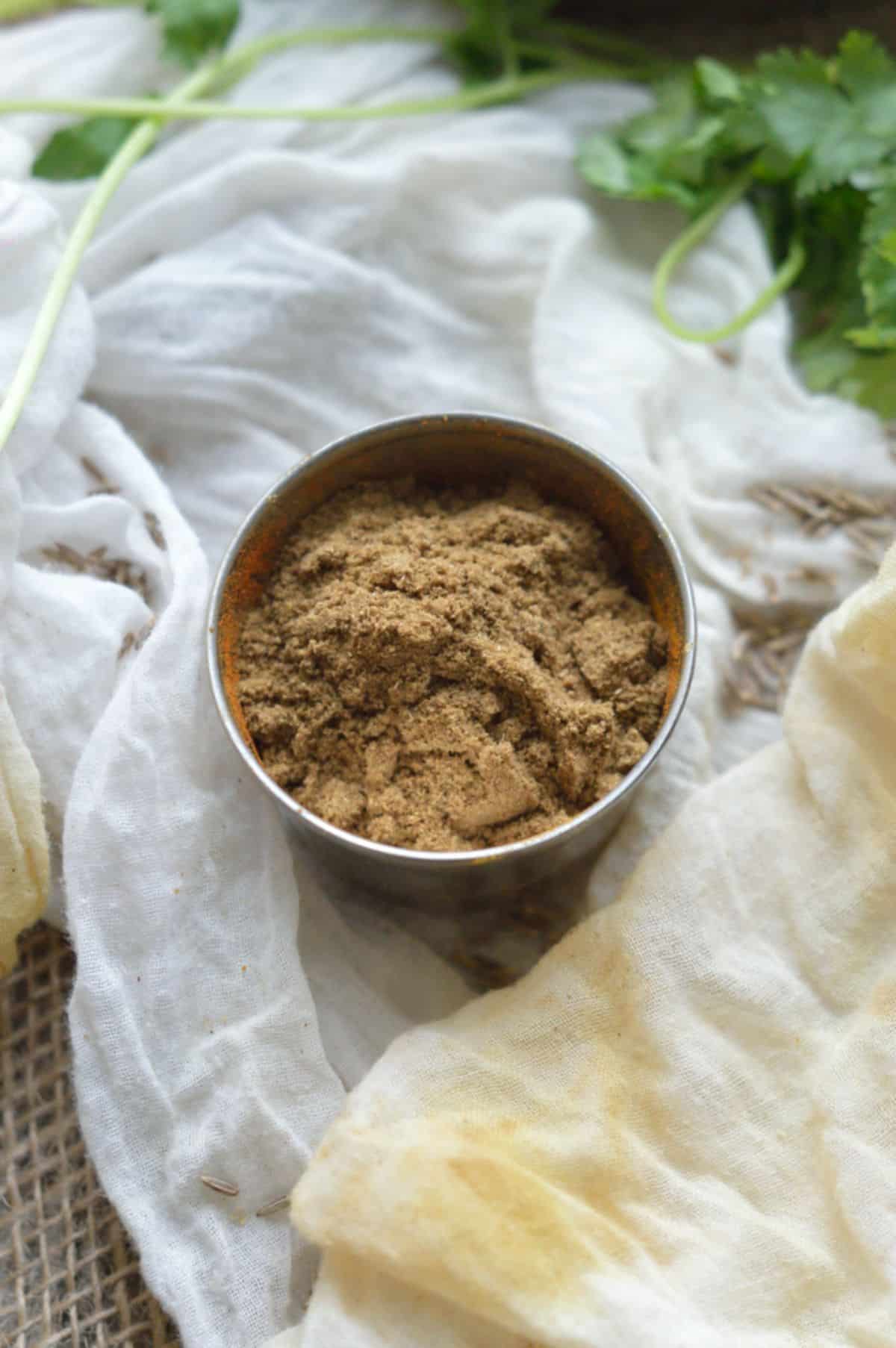 Cumin powder in a small bowl.