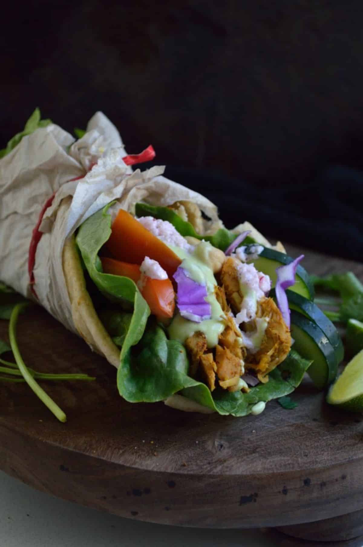 Jackfruit Curry Gyro on a wooden tray.