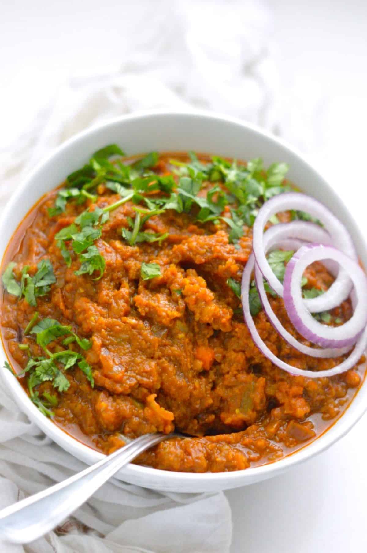 Keto Cauliflower Pav Bhaji in a white bowl with a spoon.