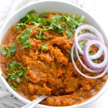 Keto Cauliflower Pav Bhaji in a white bowl with a spoon.