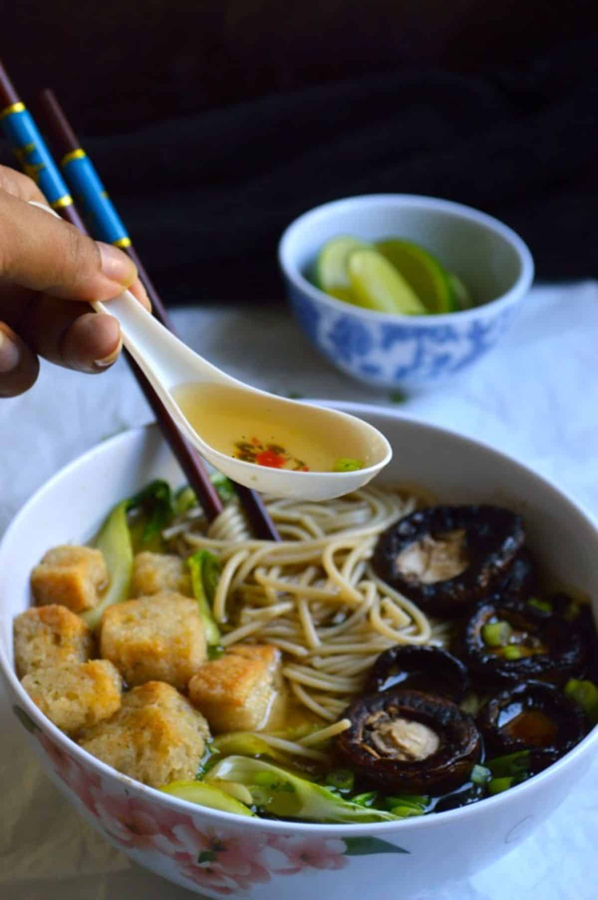 Masala Ramyun dish on a white spoon held by hand.