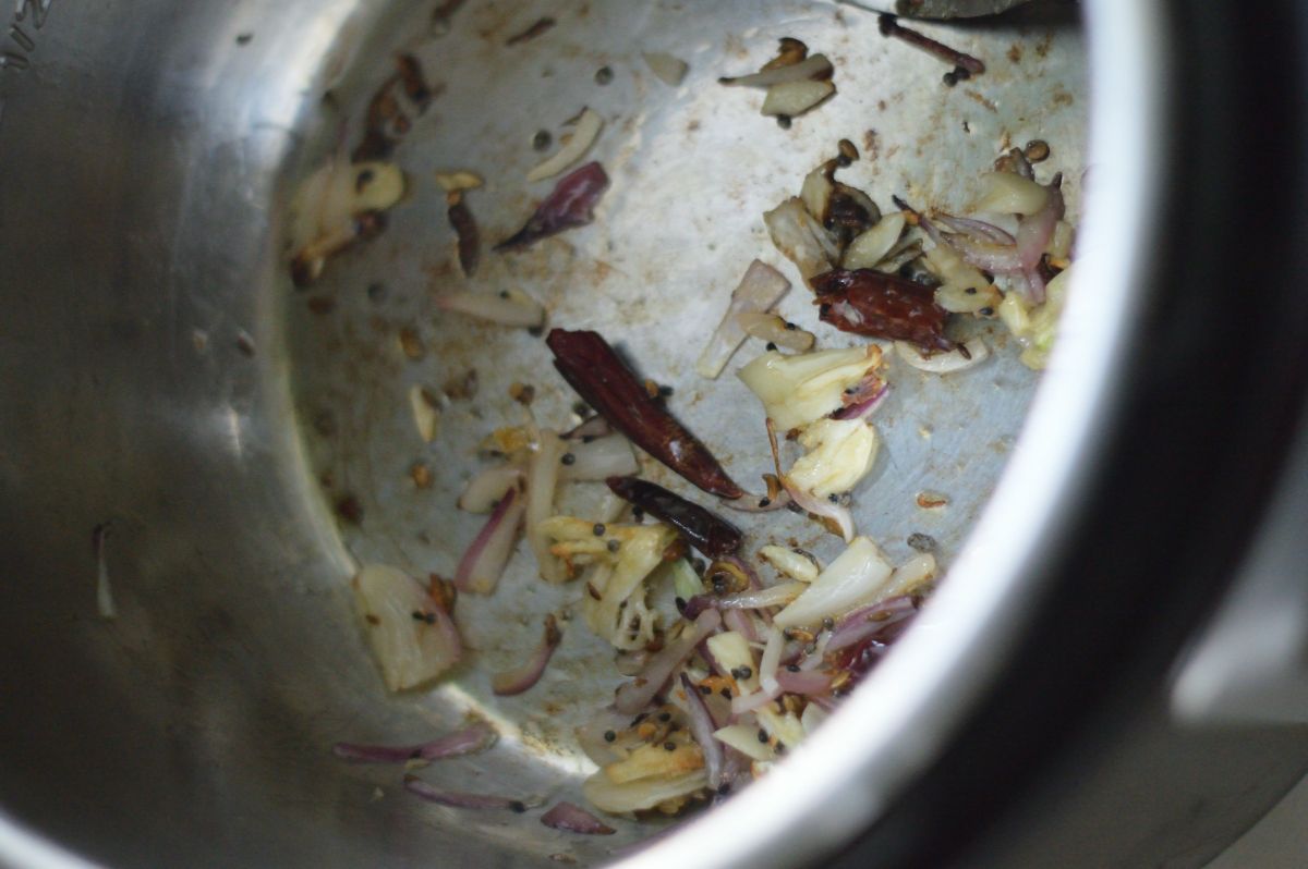 Seeds and chopped onions in a pot.