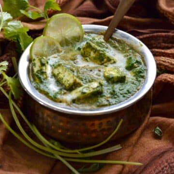 Saag Paneer dish in a bowl with a spoon.