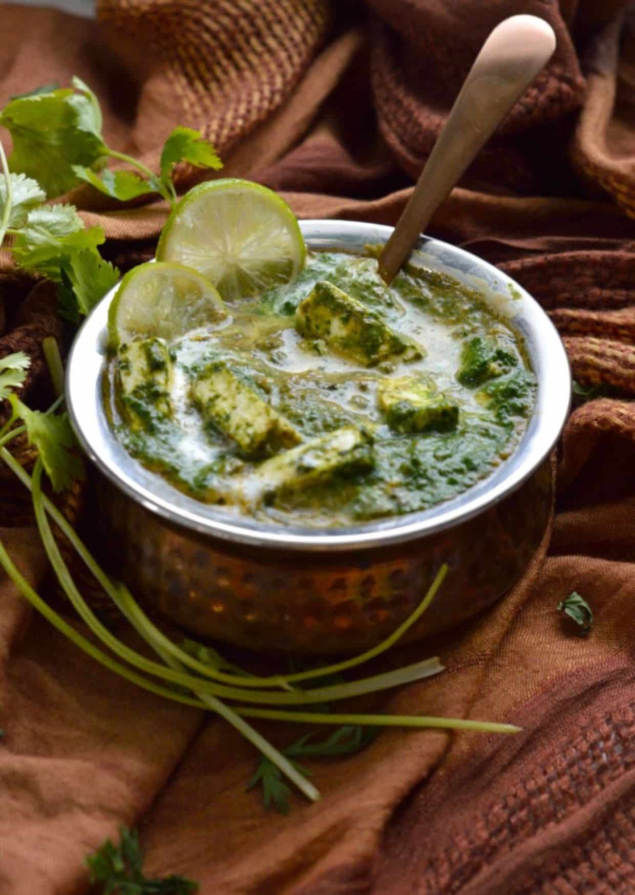 Saag Paneer dish in a bowl with a spoon.