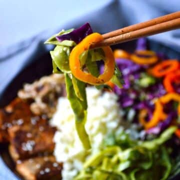 Shaved Asparagus noodles with other veggies on chopsticks.