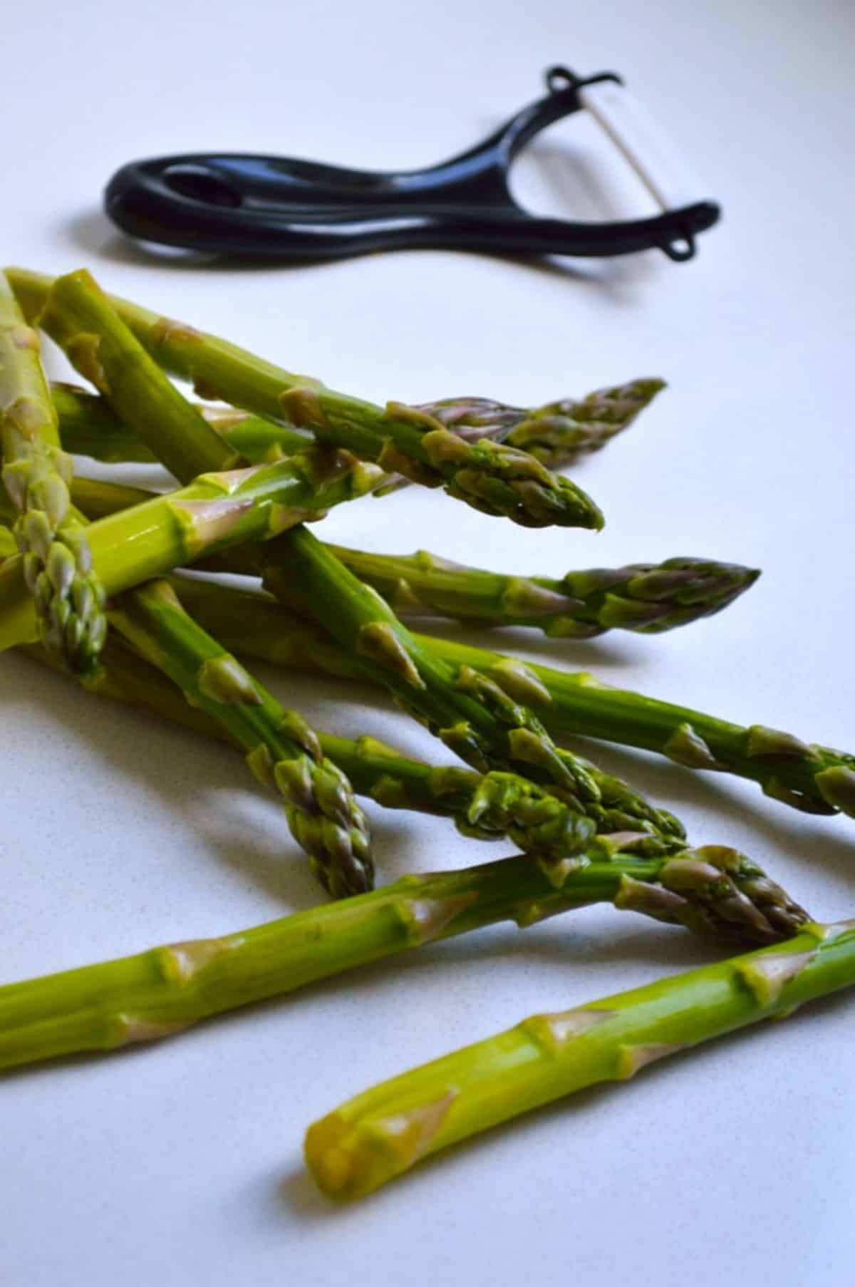 Fresh Asparagus with a peeler.