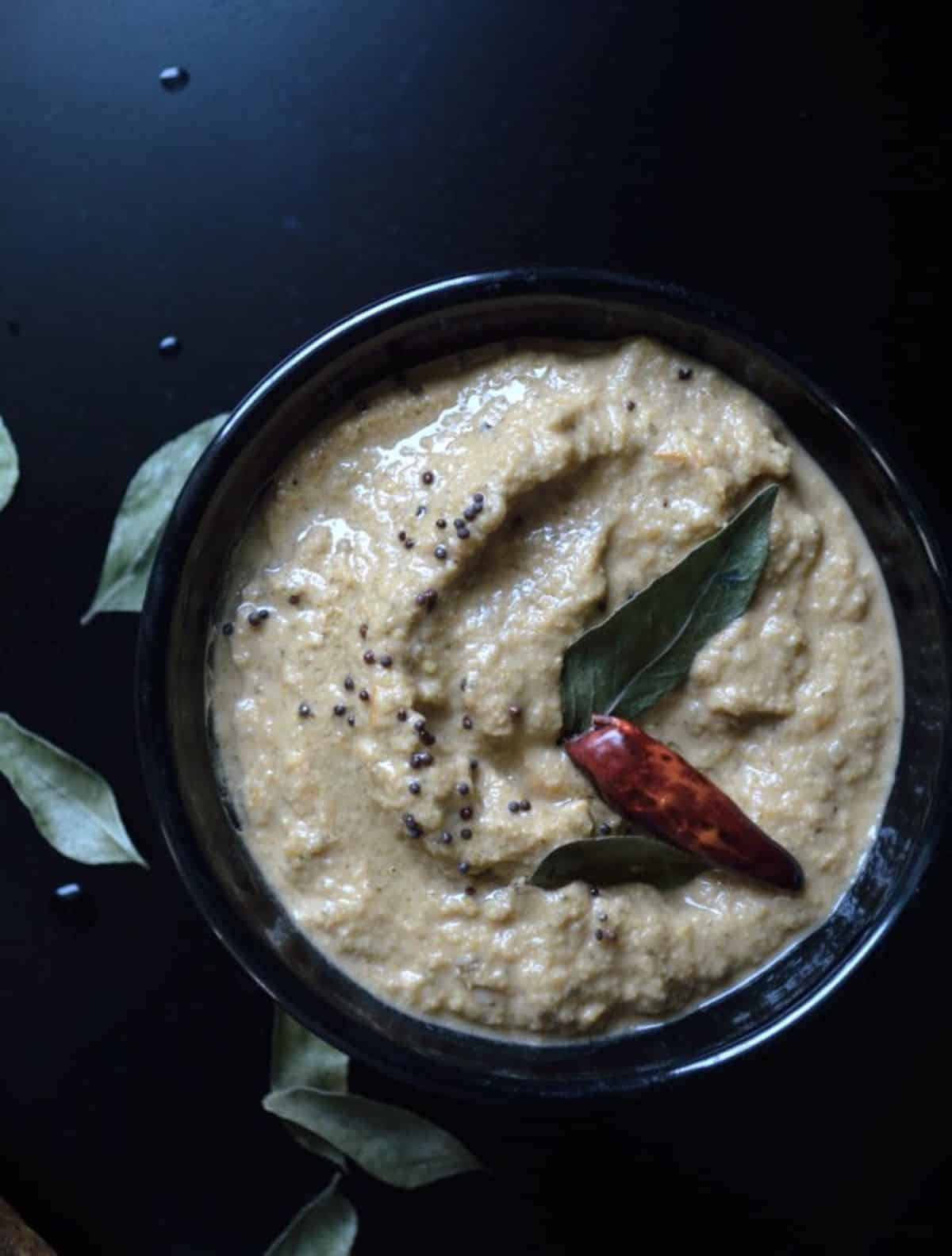 Spicy Cashew Chutney in a black bowl.