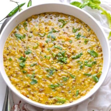 Spicy Indian Urad Dal in a white bowl.
