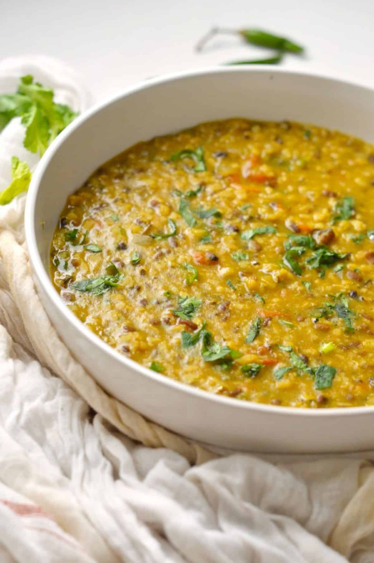 Spicy Indian Urad Dal in a white bowl.