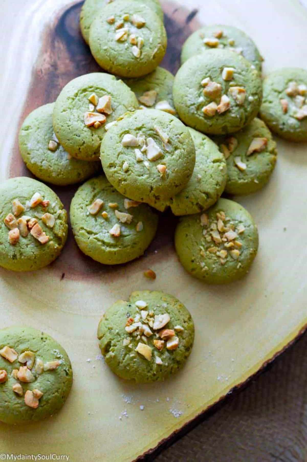 Vegan Matcha Cookies on a wooden tray.