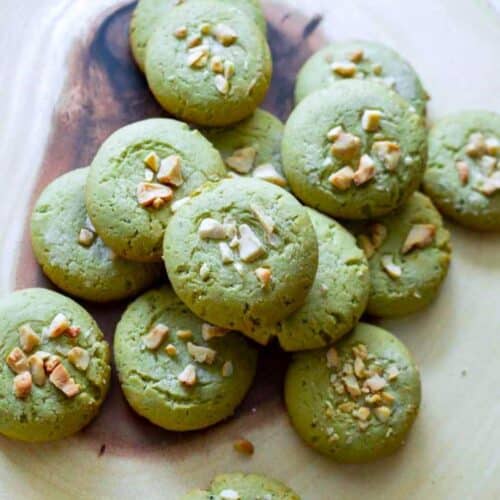 Vegan Matcha Cookies on a wooden tray.
