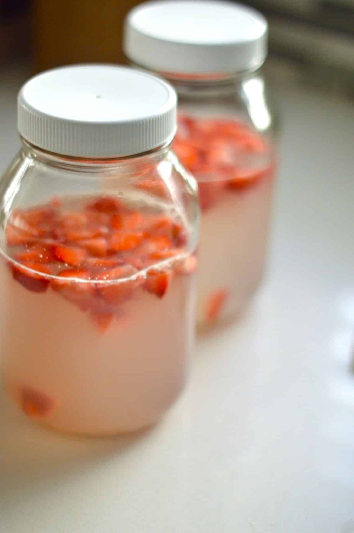 Homemade Water Kefir in glass jars.