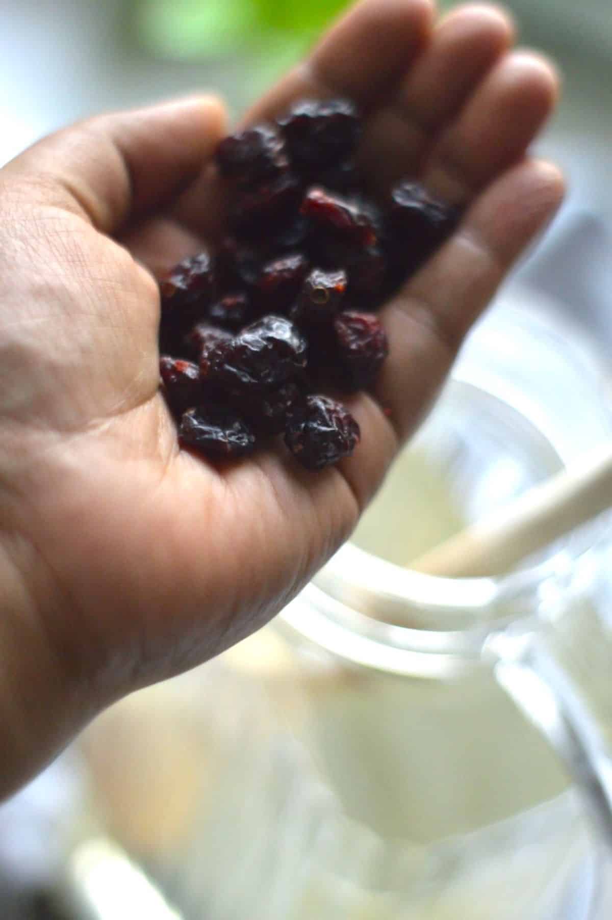 Dried fruits on a palm of a hand.