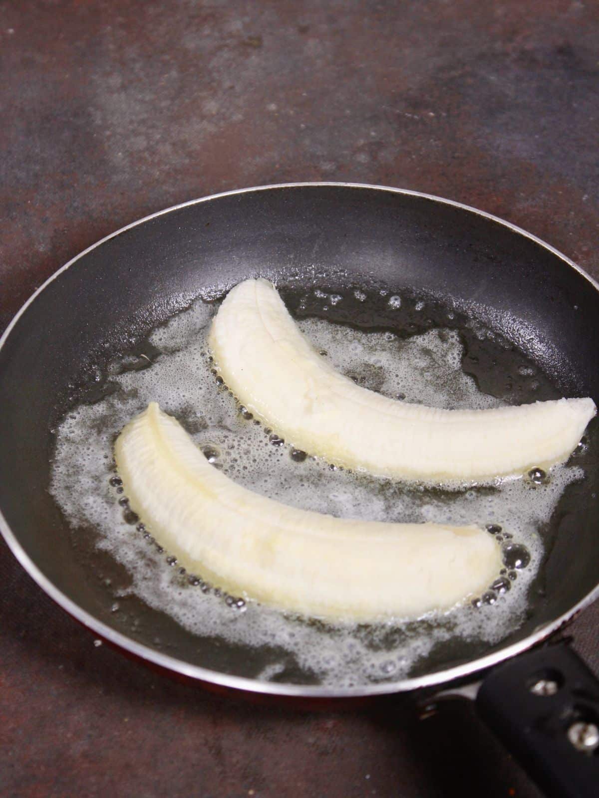 take full bananas in a pan with ghee  