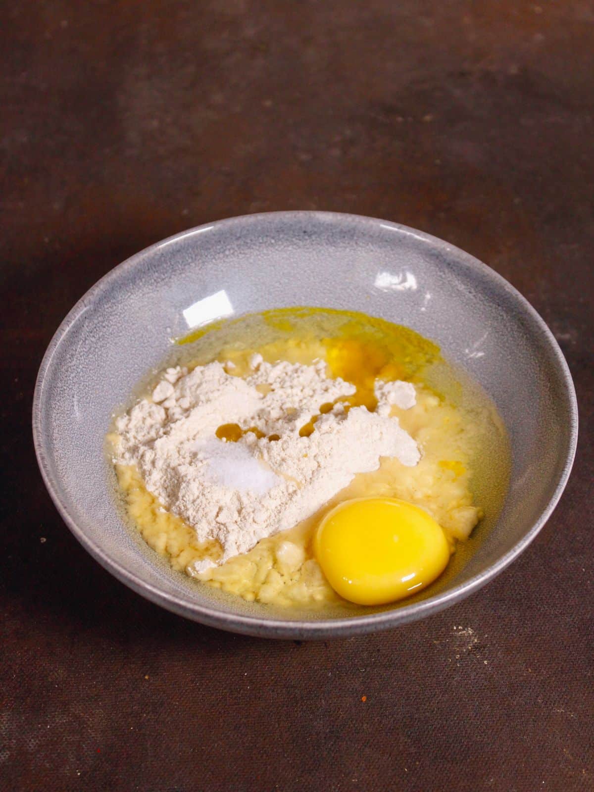 add all the ingredients of coin paratha in a bowl and make a dough out of it 