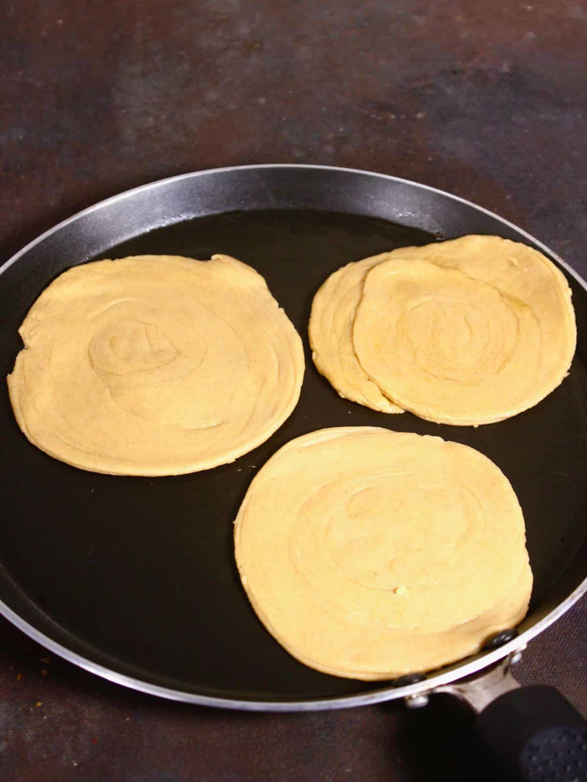 put the flattened paratha on to the pan and cook on both the sides 