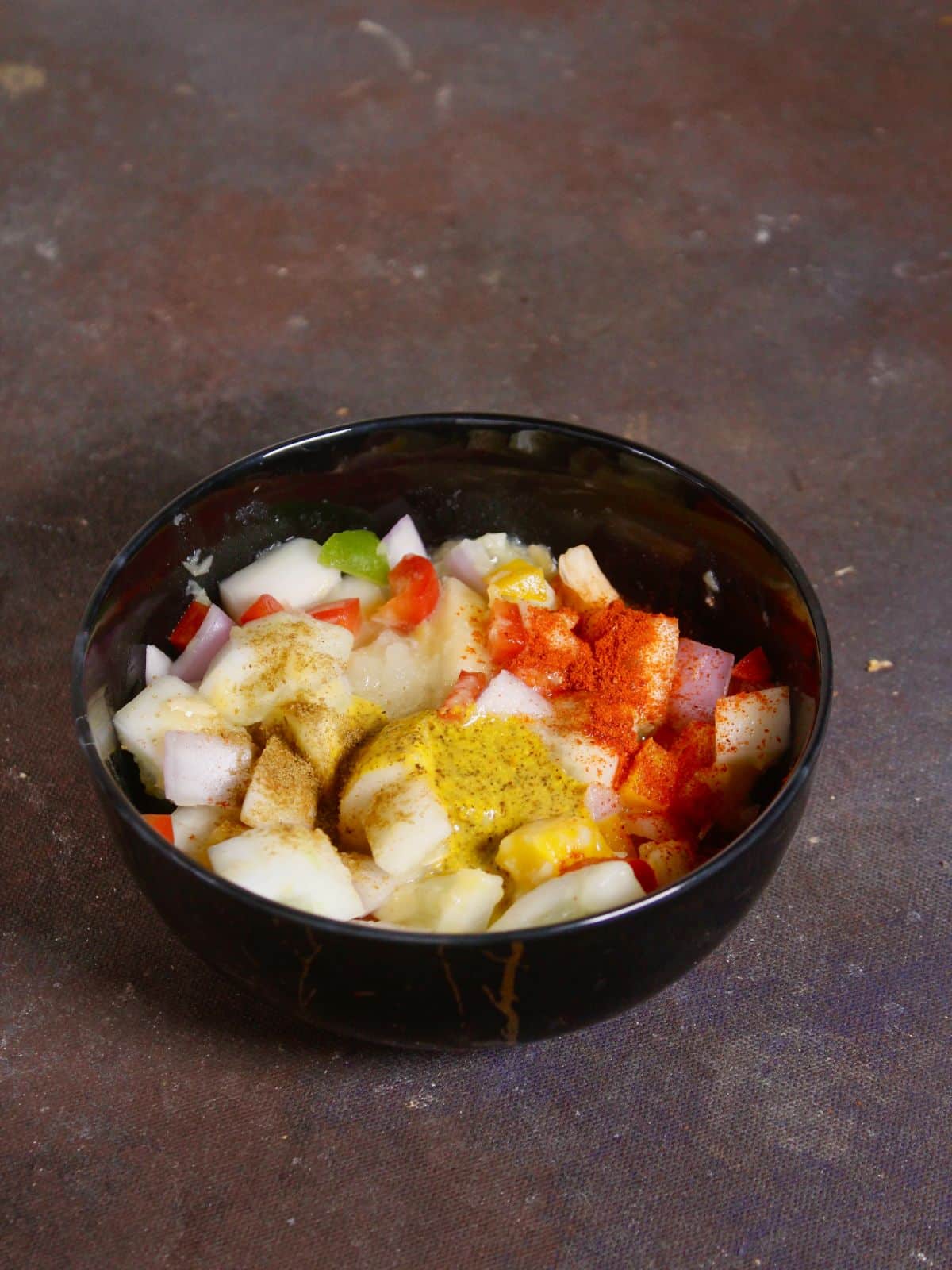 add spices and kasundi to the bowl and mix well