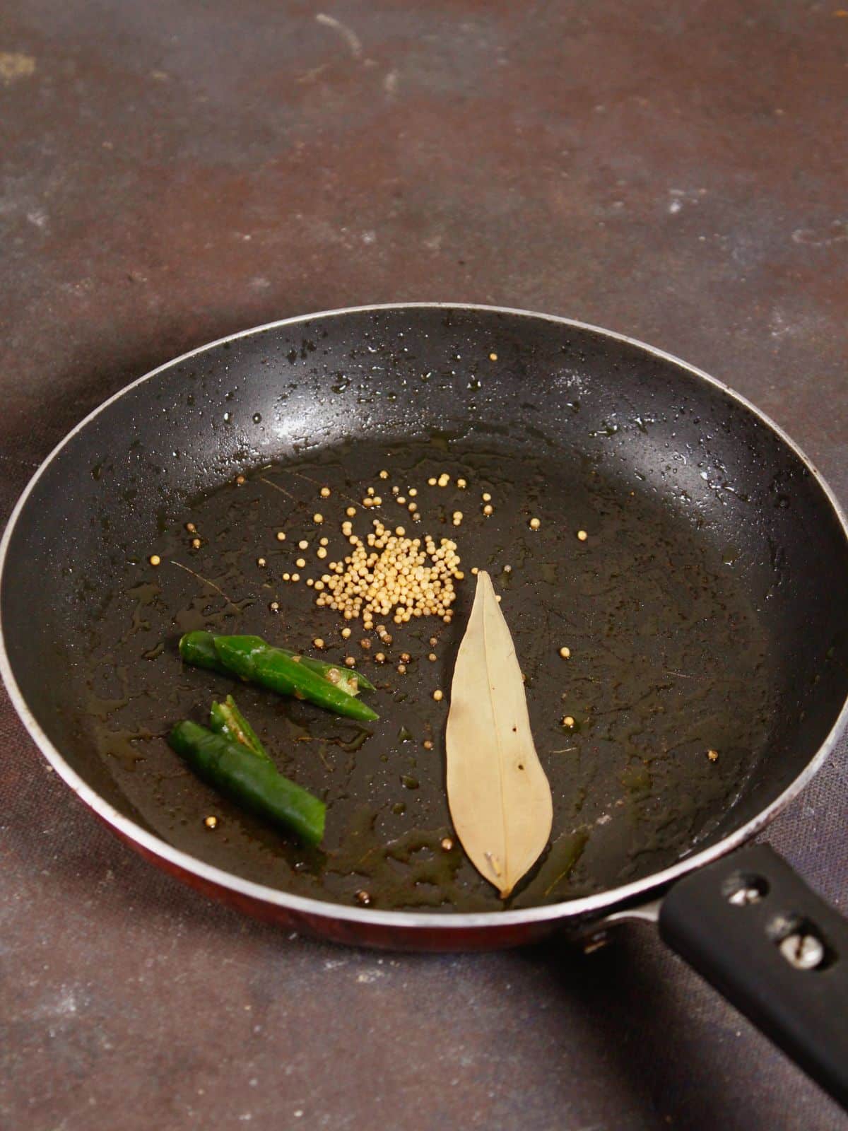 add seeds and leaf to the pan and saute 