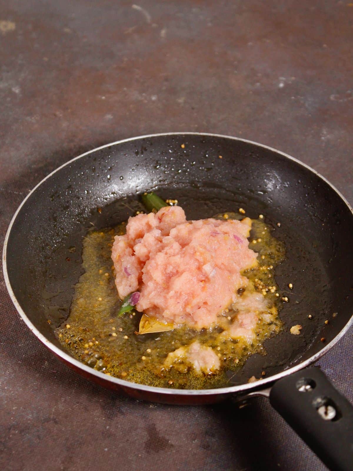 add onion tomato paste to the pan 