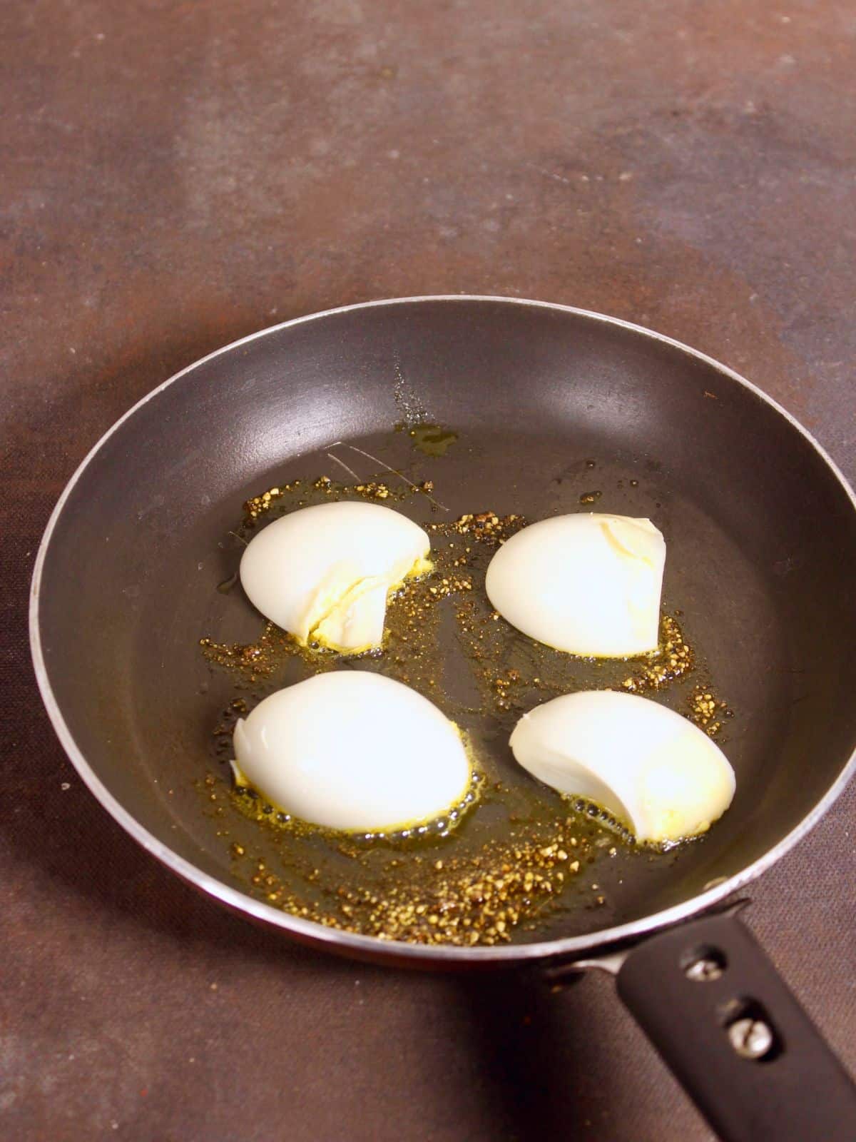 add boiled eggs to the pan 