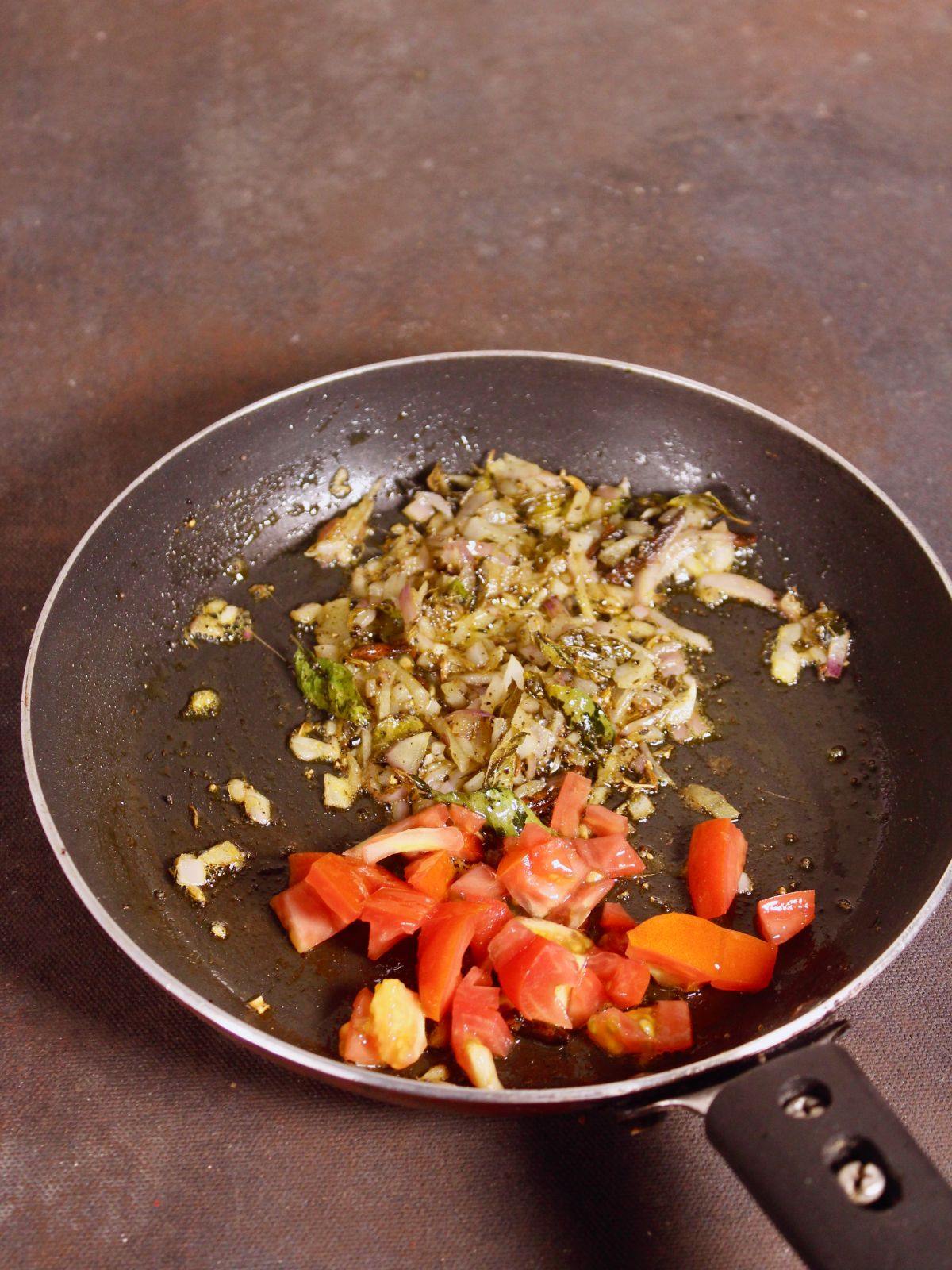 add chopped tomatoes to the pan and mix well 